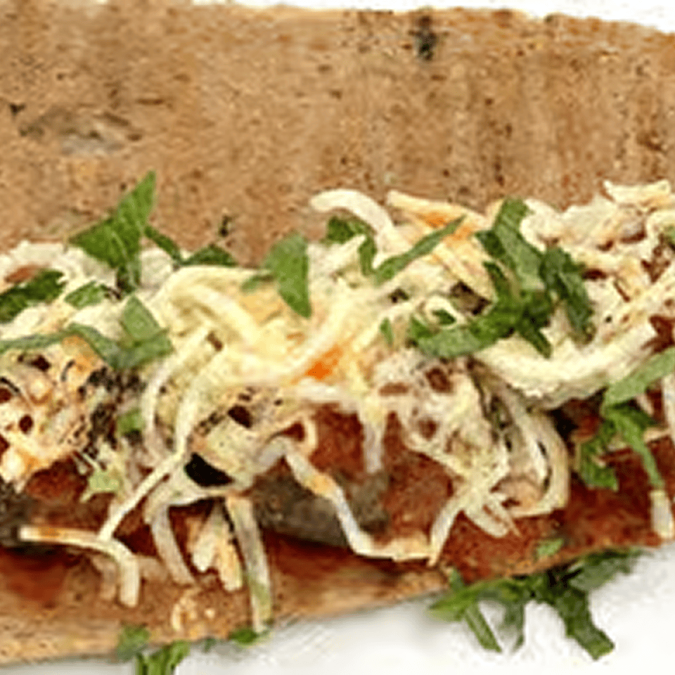 Grilled sandwich with shredded cheese and herbs