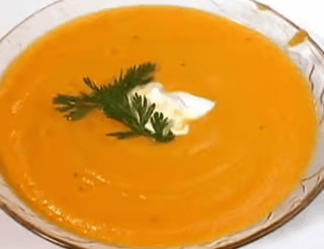 Creamy carrot soup garnished with parsley