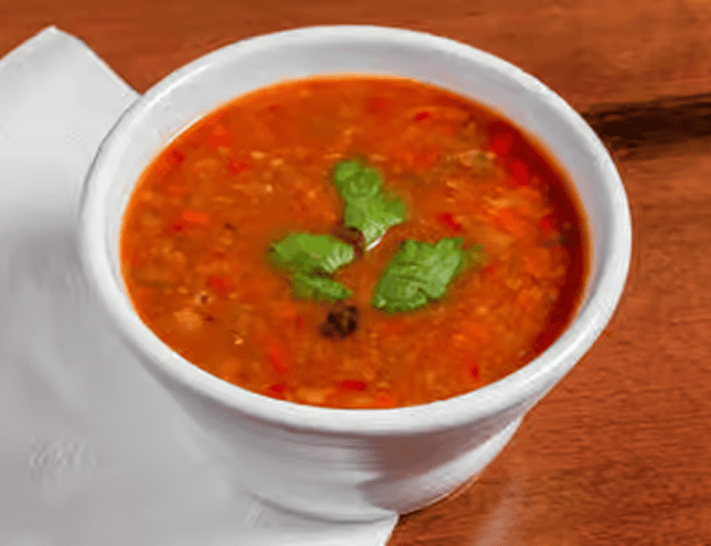 Bowl of red lentil soup on table