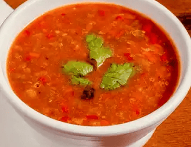 Spicy tomato soup with cilantro garnish