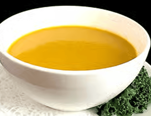 Bowl of pumpkin soup with greens