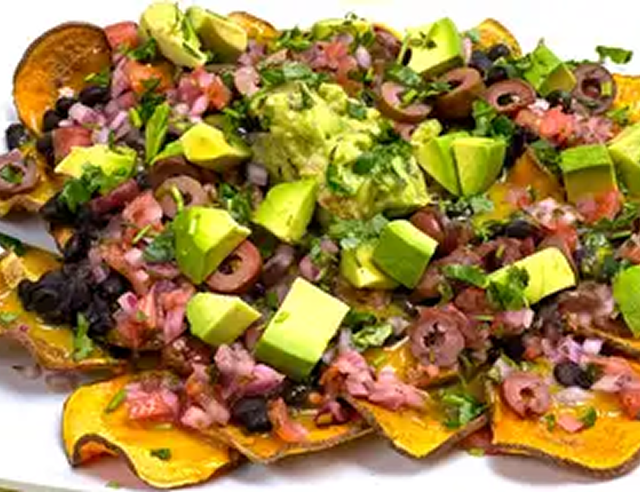 Colorful nachos with guacamole and olives