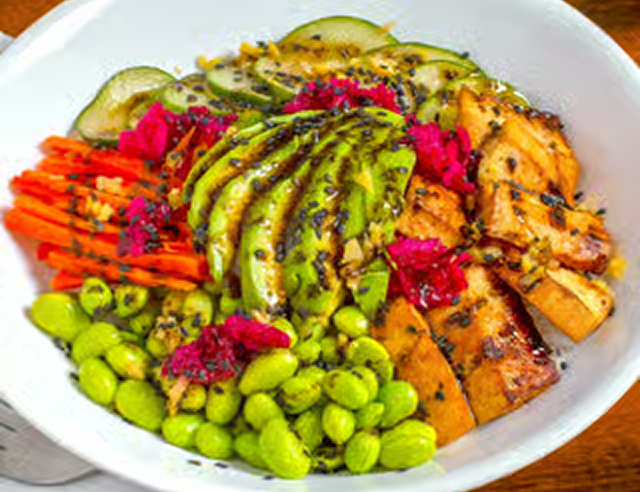 Colorful vegetable bowl with tofu and avocado.