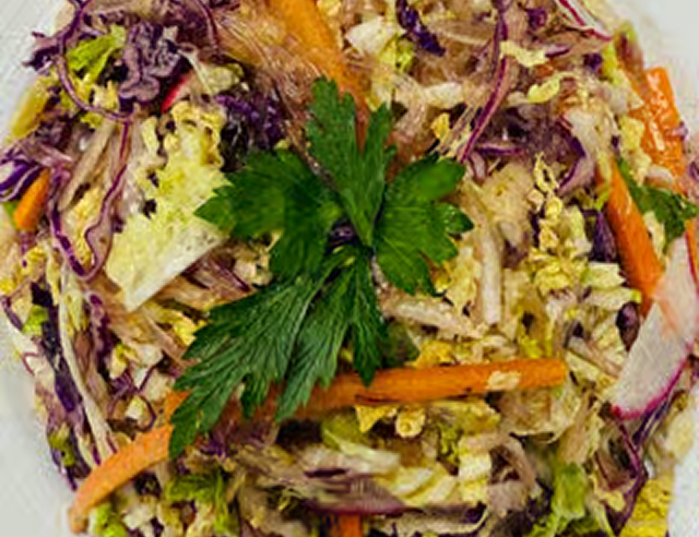Colorful cabbage salad with parsley garnish