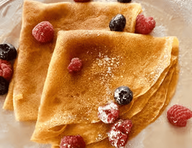 Crepes with berries and powdered sugar