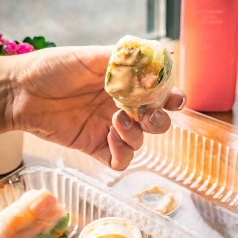 Close-up of spring roll in hand